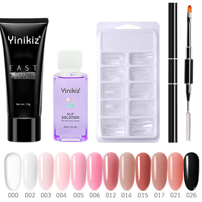 Set of poly extension nail gel including black tube, clear purple liquid bottle, white nail tips tray, and dual-ended brush.
