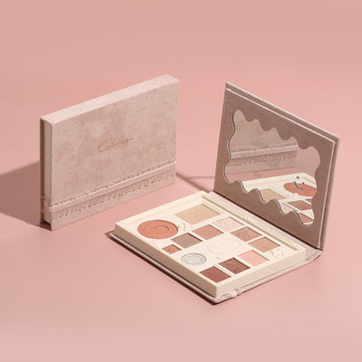 Beige compact eyeshadow palette with embossed shades, blush, highlighter, and built-in mirror.