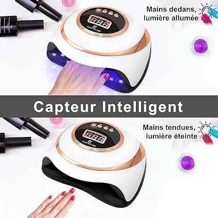 White and rose gold professional nail drying lamp with digital display and hand sensor, shown with hand inside and light on, .