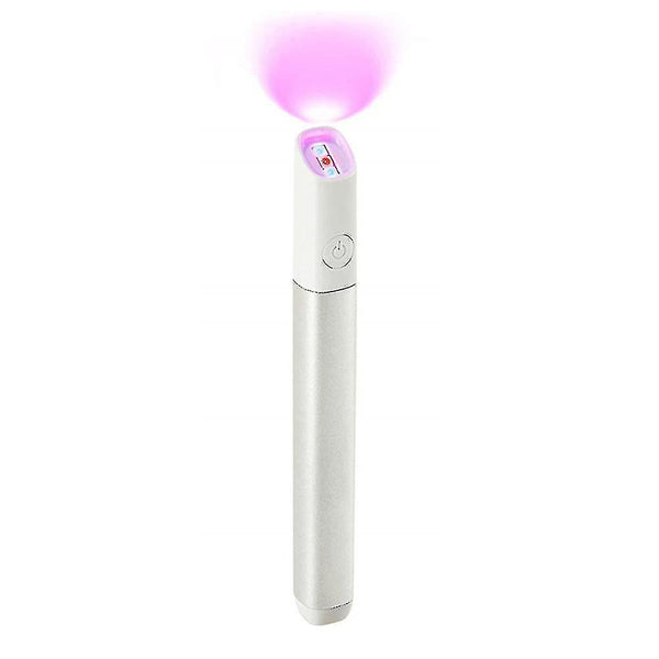 Slim white light therapy pen emitting bright pink-purple glow from top end with button on body.