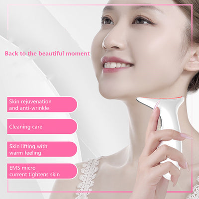 White handheld neck massager device with smooth curved design and ergonomic shape held near smiling woman’s neck.